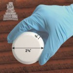Wear gloves to drop the compact Basement Wash-Dog Sump System Cleaner (WDT20) tablets into your sump pit