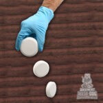 Wear gloves to drop 2-3 Basement Wash-Dog Sump System Cleaner (WDT20) tablets into your sump pit